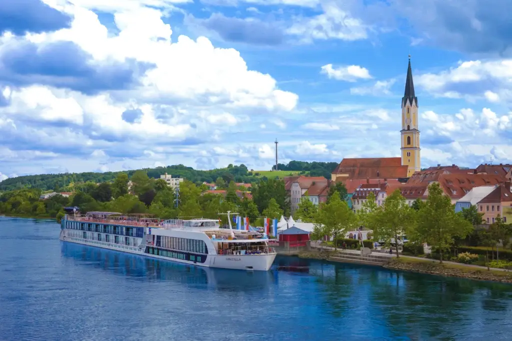 Photo-of-AmaStella-ship-sailing-past-historic-European-town-by-top-ranked-river-cruise-lines