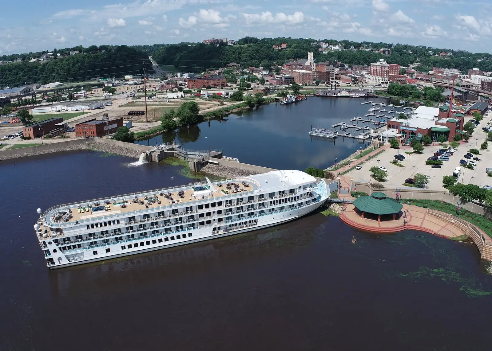 Photo-of-aerial-view-of-American-Melody-cruise-ship-docked-at-river-port-town