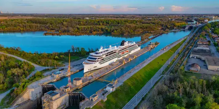Photo-of-aerial-view-of-Viking-cruise-ship-navigating-through-a-river-lock