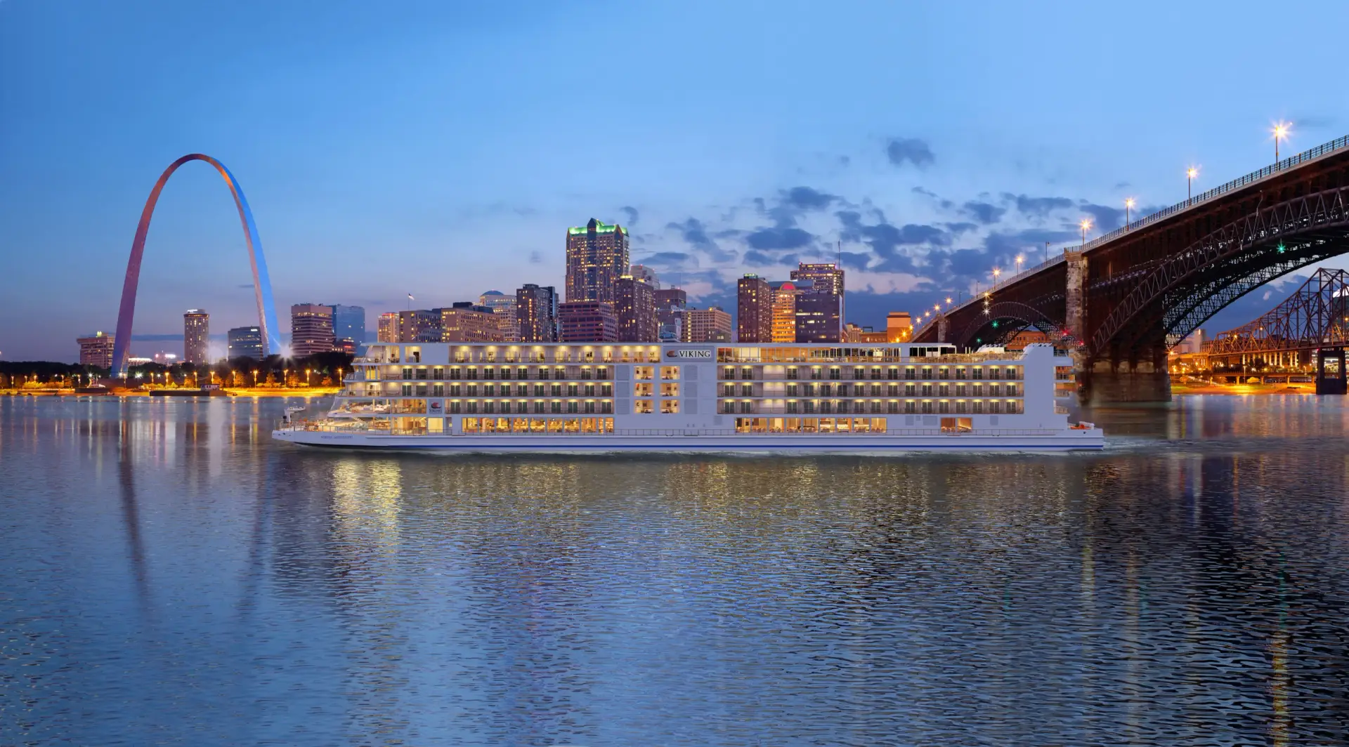 Photo of illuminated Viking cruise ship sailing at dusk past St Louis Gateway Arch
