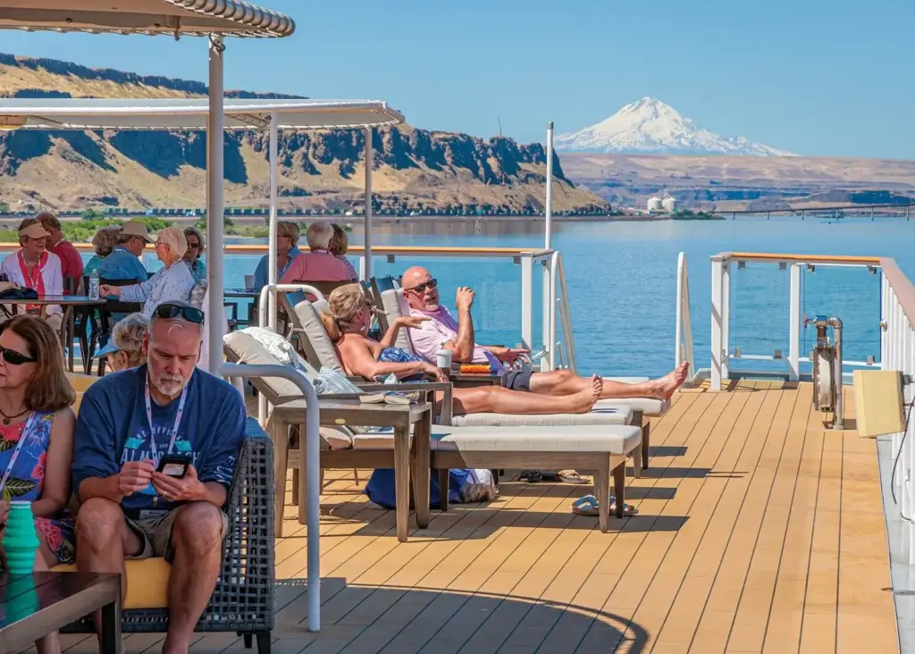 Photo guests relaxing on sun deck of American Cruise Lines ship Columbia and Snake rivers