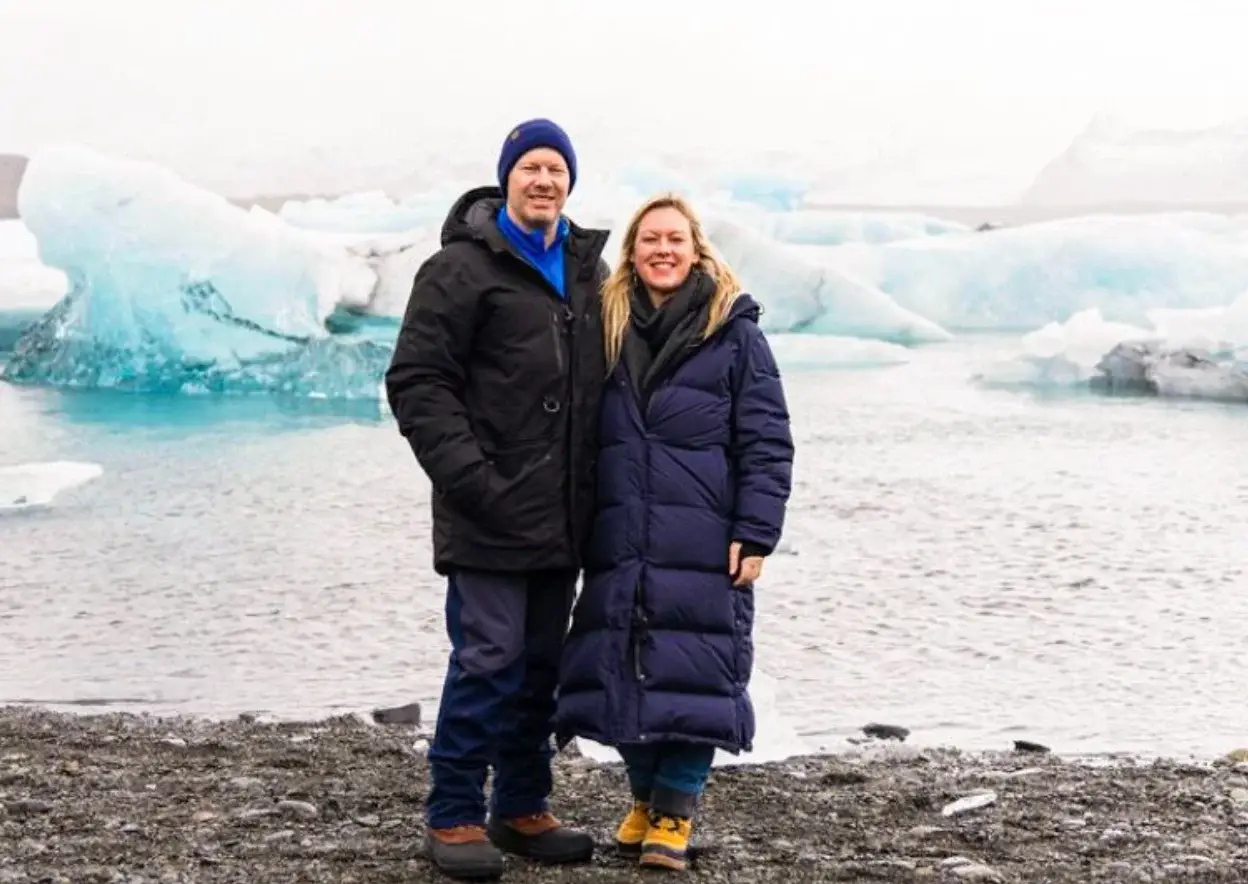Photo of Yellow Umbrella Travel owners in winter coats featured on alaska cruise packing guide
