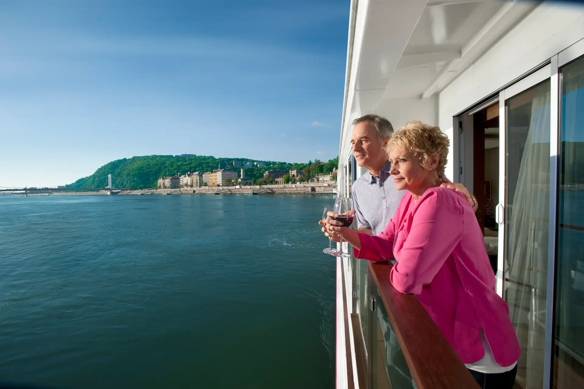 Photo of couple on Viking River Cruises stateroom balcony asking are viking cruises worth it