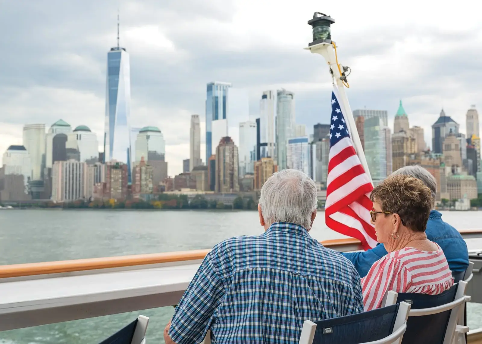Photo passengers on deck of American Cruise Lines ship viewing New York skyline Hudson River
